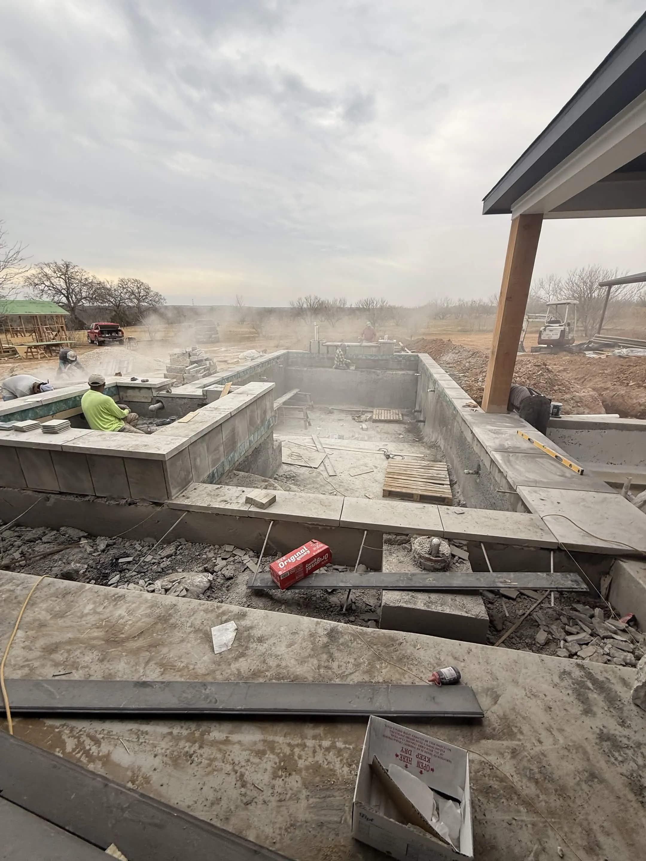 Custom pool with fire bowls and stone features