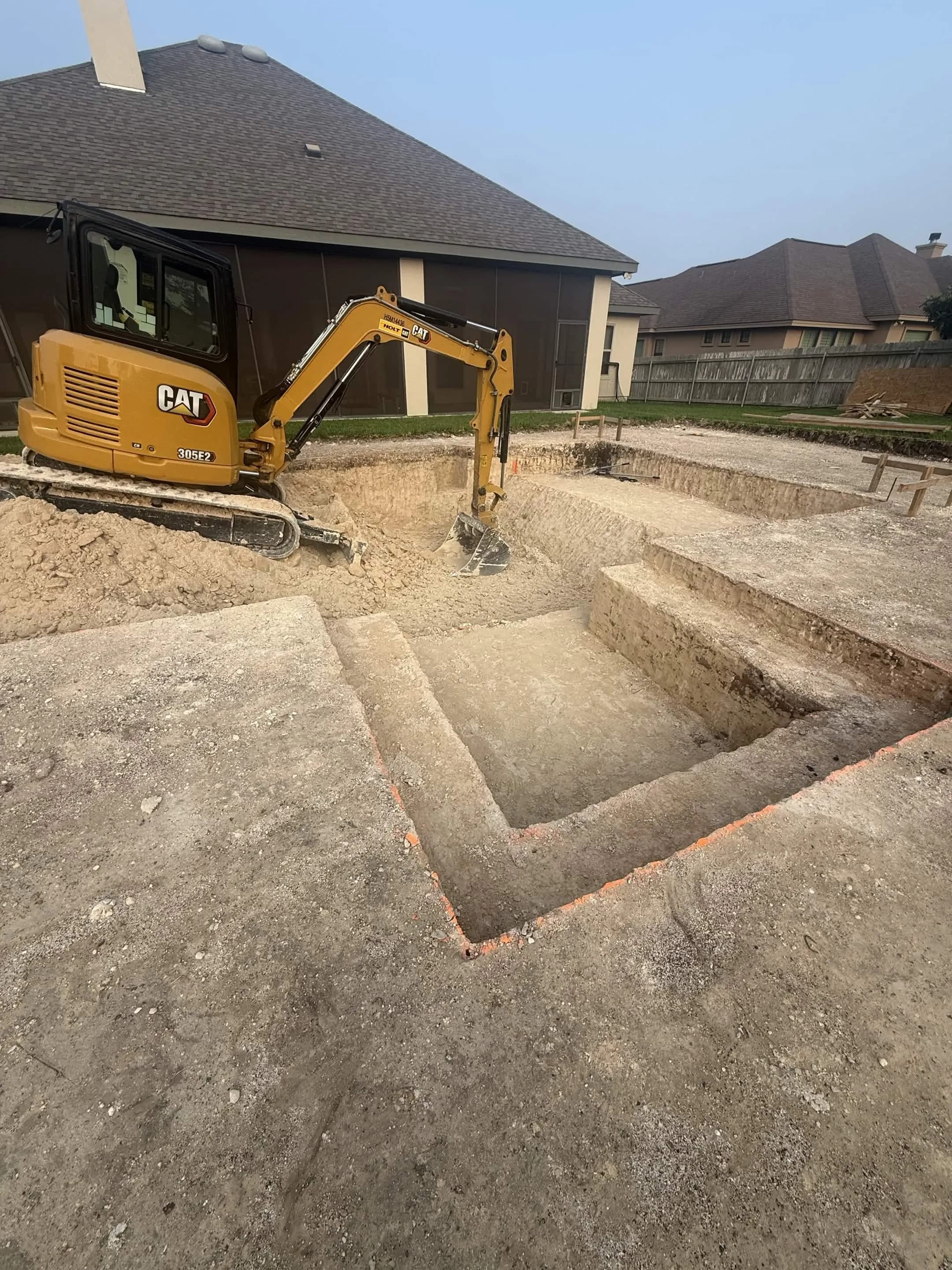 Pool excavation in Hill Country — CAT excavator digging through limestone and caliche