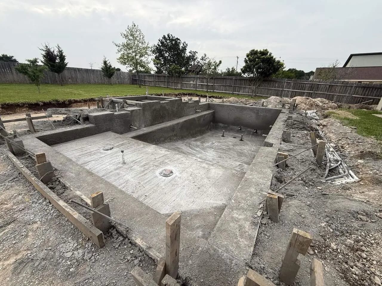 Gunite pool shell — concrete sprayed over steel rebar framework