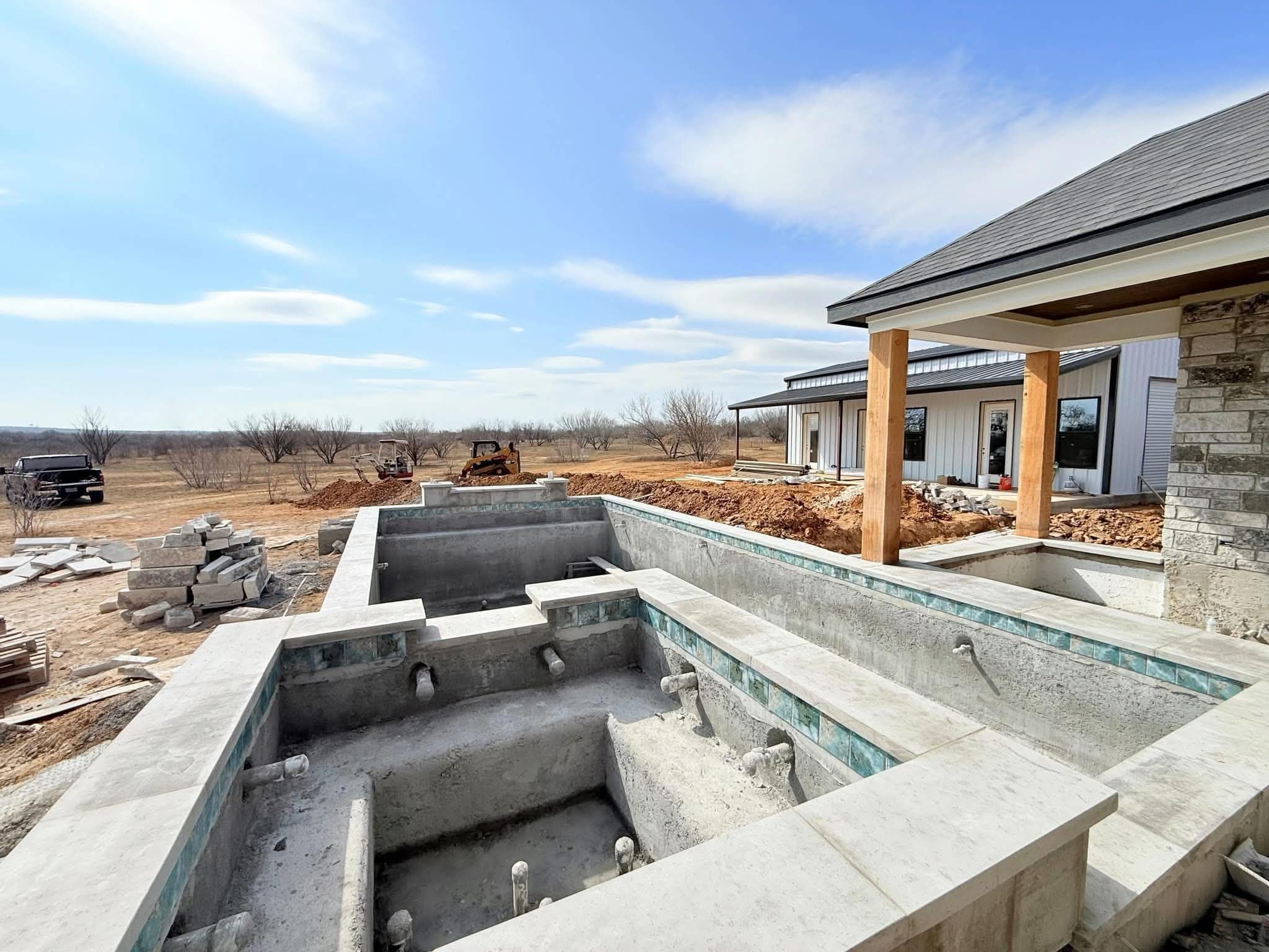 Tile and coping installation — craftsmen hand-setting each piece