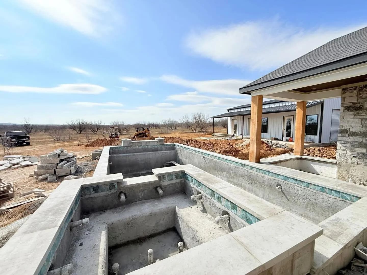 Tile and coping installation — craftsmen hand-setting each piece
